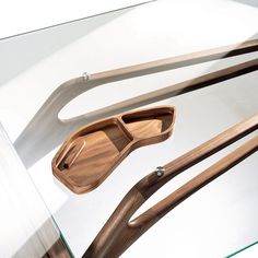 three wooden utensils sitting on top of a glass table