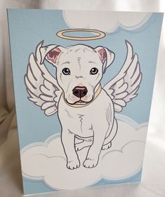 a white dog with angel wings on it's back