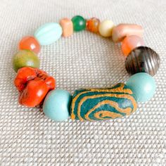 Scalia Bracelet, salty breezes, bronze skin, color bracelets. Only at BelleStyle.com. Artisan Wooden Beads Bracelets For Meditation, Turquoise Beaded Bracelets With Wooden Beads For Healing, Multicolor Large Beaded Bracelets For Meditation, Bohemian Multicolor Jewelry For Blessing, Earthy Green Bracelets For Meditation, Hand-strung Multicolor Jade Beaded Bracelets, Multicolor Artisan Bracelets For Meditation, Handmade Multicolor Jade Beaded Bracelets, Traditional Hand-strung Beaded Bracelets For Good Luck