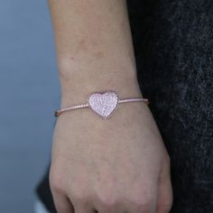 The Cubic Zirconia Heart Bangle Bracelet is a beautiful and romantic piece of jewelry that makes a perfect gift for that special someone in your life. The bracelet is designed with a delicate heart-shaped charm, which is encrusted with sparkling cubic zirconia stones that catch the light from every angle. The heart charm is attached to a high-quality metal bangle, which is both durable and comfortable to wear. The bangle itself has a sleek and modern design, making it a versatile piece that can Diamond Heart Bracelet With Heart Charm, Diamond Heart Charm Bracelet Jewelry, Diamond Heart Bracelets As Gift, Adjustable Heart-shaped Diamond Jewelry, Diamond Heart Bracelet Gift, Diamond Heart Bracelet For Wedding, Valentine's Day Cubic Zirconia Jewelry With Heart Charm, Diamond Heart Cut Bracelet As Gift, Heart Cut Cubic Zirconia Bracelet For Valentine's Day