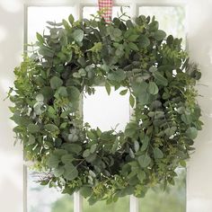 a wreath hanging on the side of a window