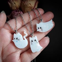 This listing is for 1 necklace of your choosing (while supplies last). Choose between A B C Handmade resin ghost kitty cabochon with a heart benzel attached on the back to create the necklace hoop. Silver tone chain and findings. Necklaces measures 10 inches from closed clasp to bottom of ghost kitty. The chain itself measures 18 inches long. Ghost kitty charm measures about 1 inch. Pet Ghost In A Jar Necklace, Cute White Nickel-free Necklaces, Cute White Nickel Free Necklaces, Cute White Jewelry With Lobster Clasp, White Kawaii Charm Necklace For Gift, Novelty White Sterling Silver Jewelry, White Sterling Silver Novelty Jewelry, Cute White Nickel-free Charm Necklaces, Handmade White Kawaii Necklace