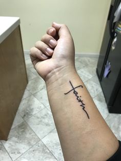 a person's arm with a tattoo that says faith