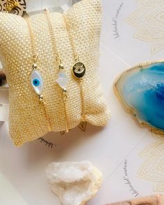 Dainty Collection  Mother of Pearl freshwater shell hamsa hand white  Mother of Pearl freshwater shell evil eye white and blue  14kt gold plated round evil eye  14kt gold plated satellite bead chain bracelet  14kt gold components Hamsa hand and Evil Eye is known for protection against those that wish bad upon you , enlightenment and good luck 🧿🪬 Please measure wrist and add half an inch for wiggle room  Example : Wrist 6 (6.5) Also add which bracelet you prefer  Example : Hamsa Hand  Beautiful Elegant White Evil Eye Bracelet Gift, White Evil Eye Jewelry Gift, White Evil Eye Jewelry, White Evil Eye Bracelets As Gift, White Evil Eye Bracelet Gift, Spiritual White Jewelry With Evil Eye, Dainty Adjustable White Evil Eye Bracelet, Gold Evil Eye Bracelet, Round Evil Eye