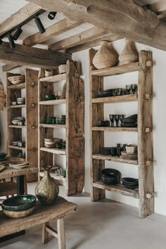 a room with wooden shelves filled with dishes