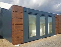 a row of portable buildings sitting on top of a dirt field