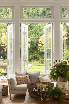 a living room filled with furniture and lots of windows