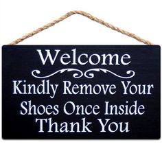 a sign that says, welcome kindly remove your shoes once inside thank you on it