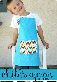 a young boy wearing an apron made out of blue material