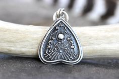 "This listing is for one gorgeously detailed and old timey sterling silver celestial Ouija planchette necklace featuring a detailed and dimensional planchette  with a crescent moon, star, and eye above dancing skeletons and the eye of the planchette. It's a very strange and beautifully unique pendant. I make these witchy pendants 100% by hand using sterling silver sheet and steel dies made as replicas of vintage jewelry designs in my hydraulic press, slowly forging the sheet into the shape. I th Celestial Engraved Silver Jewelry, Sterling Silver Celestial Jewelry For Festivals, Celestial Sterling Silver Jewelry For Festival, Celestial Style Sterling Silver Jewelry For Festivals, Silver Celestial Jewelry For Festivals, Spiritual Sterling Silver Jewelry For Festival, Celestial Silver Jewelry For Festivals, Celestial Medallion Silver Jewelry, Sterling Silver Moon Charm Jewelry