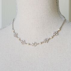 This necklace features beautiful rhinestones and ivory glass pearls . The necklace is reminiscent of the classic Regency designs of the past. It hangs about 16 1/4" long from a stainless steel chain with lobster clasp and 2" extender chain that are nickel free.   Comes in a lovely gift box with ribbon.  In the Eighteenth and Nineteenth centuries necklaces and earrings were very fashionable. Some were made of pearls, glass or gemstones and can be seen in many classic portraits. I think they're a Vintage Pearl Jewelry With Rhinestones, Victorian Pearl Charm Necklace For Wedding, Elegant Rhinestone Necklace For Vintage Events, Silver Crystal Pearl Necklace In Classic Style, Vintage Silver Pearl Necklaces, Vintage Pearl Necklaces With Rhinestones, Vintage Silver Bridal Necklace With Pearl Chain, Elegant Silver Rhinestone And Pearl Necklace, Victorian Pearl Necklace For Wedding