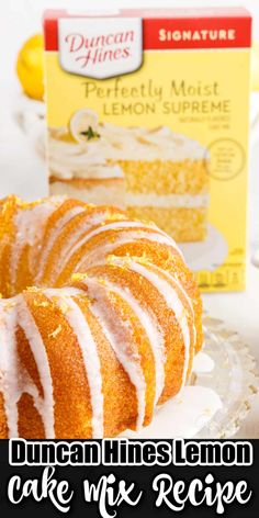 a lemon cake with white icing on a plate next to a box of duncan lines lemon cake mix