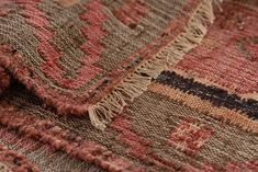 an old rug is laying on the floor with fringes and tassels around it