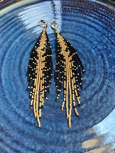 **Handmade Black and Gold Fringe Beaded Earrings** Elevate your accessory collection with these stunning handmade fringe beaded earrings. Featuring a sophisticated blend of black and gold beads, these earrings are crafted to create a striking visual effect. The elegant design makes them perfect for any occasion, from casual outings to formal events. Made with Miuyki glass beads, for lightweight and comfortable all-day wear Each earring is handmade with precision and care Ideal for both casual an Black And Gold Earrings, Fringe Beaded Earrings, Earrings Patterns, Gold Fringe, Beaded Earrings Patterns, Beads Earrings, Jewelry Black, Made Jewelry, Earring Patterns