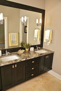 a bathroom with two sinks and mirrors in it