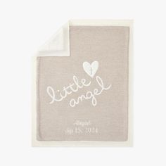 a baby blanket with the words little angel on it and a heart in white ink