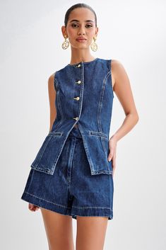 Hands down staple. Presenting the ABEL Denim Button Up Top, a modern essential for your wardrobe rotation. Boasting a round neckline and a convenient centre front button closure, this sleeveless top offers a versatile and chic aesthetic. The addition of front mock pockets adds a hint of utilitarian flair, while princess seams ensure a flattering silhouette. This longline vest is perfect for layering over various outfits, whether you're going for a relaxed weekend look with the Abel Denim Shorts Denim Decor, Long Vests, Jeans Casual, Versatile Outfits, Solid Clothes, Sleeveless Vest, Outfit Casual, Casual Elegance, Look Chic