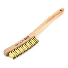 a wooden brush with gold bristles on it