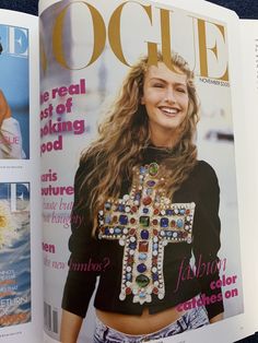 a magazine cover with a woman wearing a cross on it's chest and smiling