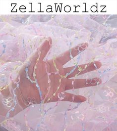 a hand that is covered in beads and plastic wrappers with the words zei law worldz on it