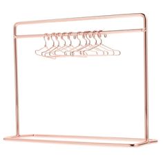 a pink metal hanger with five pairs of clothes hanging from it's sides