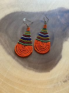 These handmade beaded earrings are truly unique. Each one is hand made with a rotating striped pattern. These earrings are available in a multitude of colors -making them perfect for any outfit! Whether it's dressing up a jean jacket or adding a unique texture to a LBD, there's no way you can go wrong with these earrings! We have given each design a name in honor of our favorite people! Please note that colors may vary a bit by pair as no two are exactly alike Multicolor Fair Trade Beaded Earrings, Handmade Casual Beaded Earrings, Artisan Orange Beaded Earrings, Casual Handmade Beaded Earrings, Multicolor Teardrop Casual Jewelry, Casual Multicolor Teardrop Jewelry, Casual Multicolor Teardrop Earrings, Casual Multicolor Dangle Beaded Earrings, Casual Multicolor Beaded Dangle Earrings