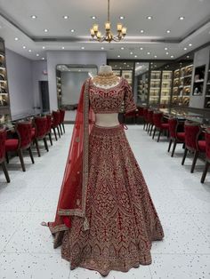 Elevate your bridal style with our stunning red lehenga adorned with mesmerizing crystal work. The radiant red hue and sparkling crystals create a captivating ensemble, exuding grace and glamour. Embrace the spotlight as you make a grand entrance, leaving a trail of timeless beauty on your wedding day. Fabric: Velvet WASH CARE INSTRUCTIONS - Please Dry clean only when it is applicable Ready to Ship! Heavy Kundan Lehenga For Reception, Red Heavy Lehenga For Festive Occasions, Heavy Red Lehenga For Diwali, Heavy Red Lehenga For Reception, Heavy Red Bollywood Lehenga, Red Embellished Bollywood Lehenga, Red Embellished Lehenga For Festive Occasions, Heavy Red Dupatta With Traditional Drape, Traditional Heavy Red Dupatta