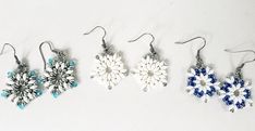 Celebrate the holidays with these festive snowflake earrings! Makes the perfect gift. Handmade with your choice of three designs: All white 5mm Czech Glass SuperDuos with 8/0 white Miyuki seed beads, 11/0 silver Miyuki seed beads and 2mm Labrador Crystals. White and  Sapphire Hematite 5mm Czech Glass SuperDuos with 8/0 Miyuki Silver Labrador seed beads, 11/0 Miyuki Crystal Labrador seed beads,  White and Crystal Silver Labrador SuperDuos, 8/0 Crystal Labrador Miyuki seed beads, 2x3mm Aqua Rondel White Beaded Christmas Jewelry, Handmade White Christmas Earrings, Handmade White Earrings For Christmas, Elegant White Holiday Earrings, Elegant White Earrings For Holiday, Christmas White Beaded Dangle Earrings, White Christmas Beaded Dangle Earrings, White Beaded Christmas Dangle Earrings, Festive White Beaded Earrings