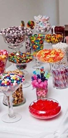 a table topped with lots of different types of candies and desserts on top of it