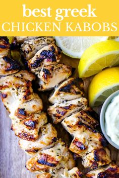 grilled chicken kabobs on a cutting board with lemons and ranch dressing