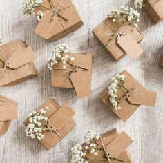 small brown boxes with white flowers tied to them