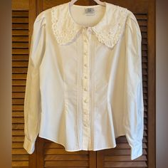 Vintage Laura Ashley Blouse Made In Hong Kong When It Was Still A British Colony Lace Detail, Pintucking, Covered Buttons, Puff Sleeves, Embroidery. Lightweight 100% Cotton. Vintage Size Us 10 / Uk 14 / Eur 40 Chest About 21” Across Sleeves About 24 1/2” Waist About 17” Excellent Pre-Owned Vintage Condition With No Obvious Rips, Tears Or Stains. Tags: Vintage, Victorian Edwardian, Coquette. Homestead, Cosplay Classic Puff Sleeve Blouse With Lace Trim, Classic Fitted Blouse With Peter Pan Collar, Classic Blouse With Lace Trim And Puff Sleeves, Fitted Classic Blouse With Lace Trim, Feminine Fitted Blouse With Peter Pan Collar, Classic Fitted Blouse With Lace Collar, Ashley White, Sleeves Embroidery, Vintage Laura Ashley