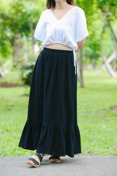 Size S-M Waist  24-32" Hips 34-42" Length 34" Size M-L Waist  32-40" Hips 42-50 Length 34" White color includes lining for modesty. Model is 5′2″ (158cm) tall with a 81cm/32″ bust, 69cm/27″ waist, 92cm/36″ hips Crafted from the finest double-layered muslin gauze, this skirt promises a delicate touch and an exquisite drape that flows gracefully with every step you take. The lightweight, breathable fabric ensures comfort and ease, making it perfect for warm days or layered looks in cooler weather. The skirt features a full-length design that exudes elegance and femininity. Its comfortable elastic waistband provides a flexible, snug fit, catering to a range of body types and sizes. The subtle texture of the gauze adds a rustic, yet sophisticated appeal, while the skirt's simplicity makes it a Casual Long Skirt With Ruffle Hem, Flowy Long Skirt With Ruffle Hem, Casual Long Ruffled Skirt, Casual Maxi Skirt With Ruffles, Cotton Tiered Ruffle Maxi Skirt, Cotton Flowy Tiered Skirt, Solid Cotton Tiered Maxi Skirt, Solid Color Cotton Tiered Maxi Skirt, Tiered Cotton Maxi Skirt With Ruffles