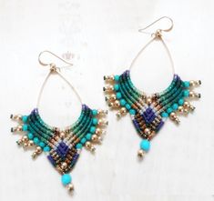 *IMPORTANT* all jewelry orders will be processed after October 26th. Thanks for your patience =) bollywood earrings, bellydance earrings, tribal earrings, turquoise earrings, yoga earrings, colorful earrings, artisan earrings, southwest earrings, boho earrings, ethnic earrings, indian earrings. These earrings are tribal and colorfull. Since they are made mostly from cord, they are relatively light weight.  I weave each pair using high quality waxed cord which will not fade or fray and is waterproof.  I used howelite turquoise beads, muiki beads and brass beads on a high quality brass drop. Earwires are goldfilled. Dimensions:  Length: 6.5 cm // 2.5 inch (including the earwires) width: 4 cm // 1.6 inch I make each paur to order, so please allow 5-7 days for me to make them for you in additi Bollywood Earrings, Yoga Earrings, Trendy Nail Art Designs, Earrings Indian, Earrings Colorful, Micro Macramé, Artisan Earrings, Earrings Turquoise, Brass Bracelet