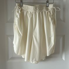 Free People Movement Ivory Shorts. Nwot Size S. Definitely Fits A Med. Ruched Sides. Adjustable Elastic Waist With Side Ties. Fully Lined. Silky Soft. Oversized Reposh From @Faith_warrior13. Just Didn’t Fit Me. Excellent Condition. Exact Same Pair Sold On Posh For $56. Spring Cream Bottoms With Built-in Shorts, Chic White Bottoms With Drawstring, White Drawstring Bottoms For Daywear, Chic White Drawstring Bottoms, Beige Drawstring Shorts For Day Out, Beige Summer Shorts For Daywear, Summer Beige Shorts For Daywear, Chic Off White Shorts, Cream Bottoms With Elastic Waistband, Short Length