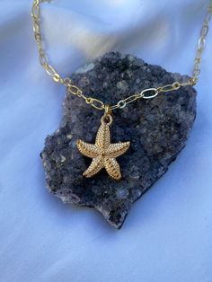 ♥Set your inner beach girl free with this cute beach-themed gold starfish necklace! This gold plated necklace is tarnish free and won't cause any allergic reactions!  ♥Paired with our gorgeous gold rolo chain. ♥MATERIAL -16K gold plated over brass -nickel-free, hypoallergenic, tarnish-free Plated jewelry is a wonderful, affordable way to add a sophisticated look to your wardrobe, with the look of real gold. It is also an excellent choice for people with sensitive skin. ♥CARE TIPS - Avoid contact with perfumes, body oils, and other chemicals, including household cleaners. Never use chemical jewelry cleaners as these will do more harm than good. - For light cleaning, gently polish with a soft, lint-free cloth to avoid scratching. - Store it in a cool dry place. ♥Delicately handmade in Los An Gold Star Charm Necklace For Beach, Gold Charm Necklace With Star For Beach, Gold Charm Necklace With Star Charm For Beach, Beach Star Charm Necklace, Dainty Gold Starfish Charm Necklace, Ocean-inspired Starfish Charm Necklace For Vacation, Vacation Ocean-inspired Starfish Charm Necklace, Gold Jewelry With Starfish Charm As A Gift, Gold Jewelry With Starfish Charm For Gift