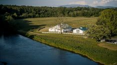 an aerial view of a farm with a river running through it