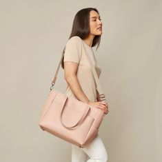 This structured tote is the ultimate do-it-all bag that you deserve. It's the perfect carryall for work, travel, and anywhere your day brings you. It features a spacious and organized interior for your essentials, a padded compartment for your laptop, side pockets for your drinks, and you can convert it into a backpack or crossbody. Crafted from premium American Saffiano leather that's waterproof and scratch-resistant, the Transform Tote will stay just as beautiful through all your travels and a On-the-go Laptop Bag With Detachable Double Handle, On-the-go Briefcase With Double Handle, Chic On-the-go Diaper Bag With Double Handle, On-the-go Tote Briefcase With Detachable Handle, Versatile Top Handle Laptop Bag With Removable Pouch, Elegant Large Capacity Laptop Bag For On-the-go, Modern Tote Diaper Bag For On-the-go, Elegant Weekender Bag With Adjustable Strap For On-the-go, Functional Everyday Satchel With Detachable Handle