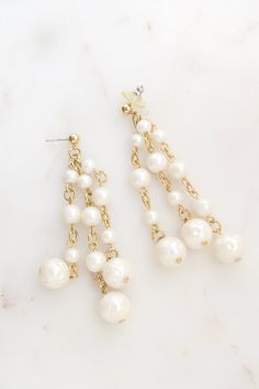 "Vintage Faux Pearl Tassel Earrings. Length: 3 1/8\" Total weight: 17.7 grams Good vintage condition! Back to the shop: https://www.etsy.com/shop/SusVintage?ref=hdr_shop_menu Don't hesitate to contact me if you have any further questions. Thank you for looking!!" White Pearl Charm Chandelier Earrings For Party, Pearl Chandelier Earrings With Dangling Beads, Pearl White Dangling Bead Earrings, Pearl Chain Dangle Chandelier Earrings, White Dangle Clip-on Earrings, Pearl White Dangle Earrings With Beads, White Chandelier Earrings With Pearl Chain For Party, White Pearl Chain Earrings With Round Beads, White Pearl Drop Dangle Cluster Earrings