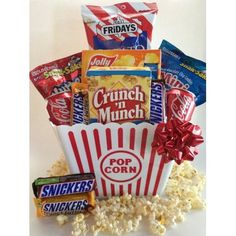 a popcorn box filled with snacks and candy