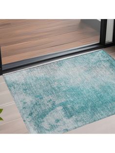 a blue area rug on the floor in front of a glass door