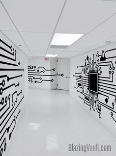 an empty room with black and white designs on the walls