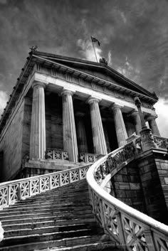 a very tall building with some stairs leading up to it's top and the sky in the background