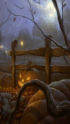 a pumpkin sitting on top of a pile of leaves next to a wooden fence in front of a forest