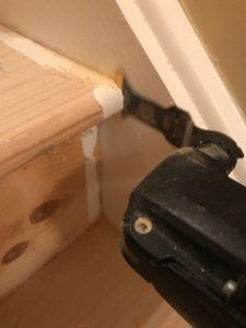 a close up of a tool on the side of a wooden floor next to a wall