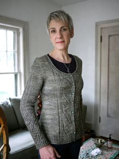 an older woman standing in front of a table