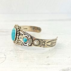 Vintage Old Pawn Sterling Silver Turquoise Cuff Bracelet - Applied Thunderbird - Hand Stamped Details - Arrows- Rising SunA gorgeous hand-crafted Navajo sterling silver and turquoise cuff bracelet. It is very well made with applied thunderbirds, studs, and many other hand-stamped details.The central oval turquoise cabochon measures 5/8 inch (17mm) by 7/16 inch (12mm).The two small round cabochons measure 1/4 inch (6mm) in diameter.It measures 5 1/4 inches long with a 1 1/2 inch gap at the bottom Turquoise Bracelet Cuff, Turquoise Cuff, Chatelaine, Silver Turquoise, Turquoise Sterling Silver, Cuff Bracelet, Hand Stamped, Anklets, 4 Inch