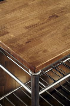 a wooden table with metal legs on a wood floor