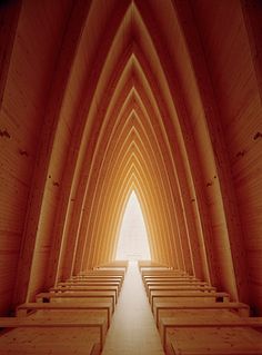 the inside of a church with rows of pews lined up in front of it