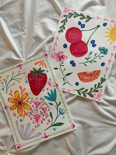 two cards with fruit and flowers painted on them